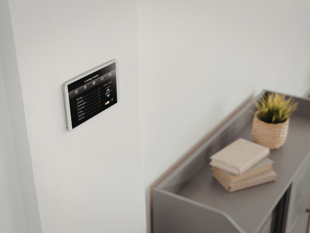 A smart home wall-mounted control panel used for lighting and scene control in a modern home interior.